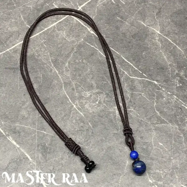 Lapis Lazuli pendant necklace laid flat showing deep blue and golden flecks – Master Raa