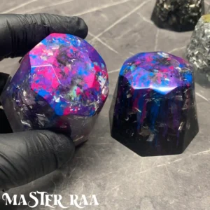 Two large colour splash orgone harmonisers side by side, showing variety in resin colour patterns.