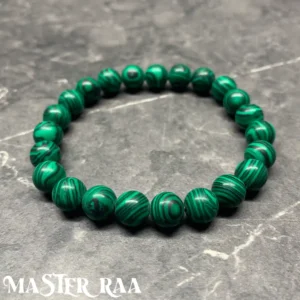 Malachite crystal bracelet with polished rich green beads, laid flat on Grey background