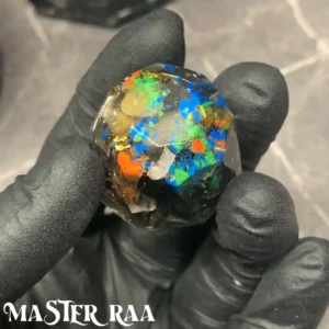 Detailed close-up of a single mini octagon orgone piece, showcasing its layered crystal and metallic design.